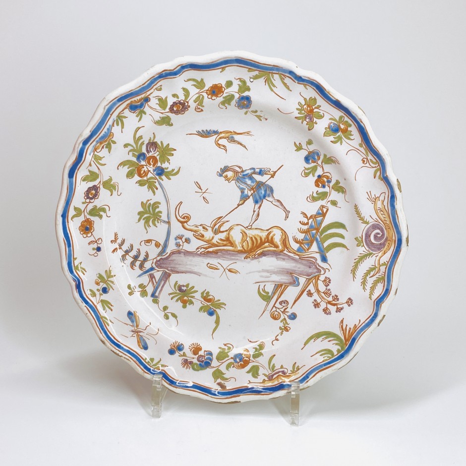 Earthenware plate from Lyon decorated with a man slaying a grotesque animal - Eighteenth century